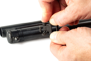Sling Swivel Mount Attachment to Mossberg 500 stud step two, turning the lock pen out